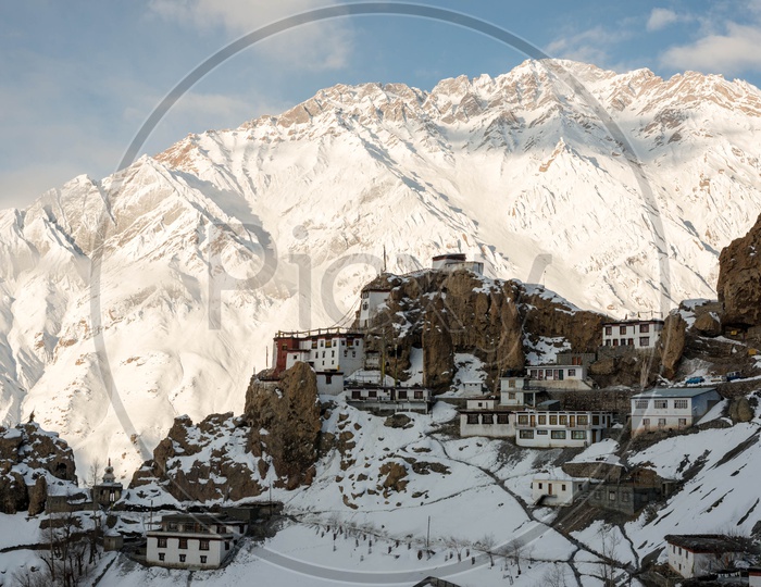 Dhankar Village on Mountain Covered in Snow with Snowy Himalaya Mountains in Background