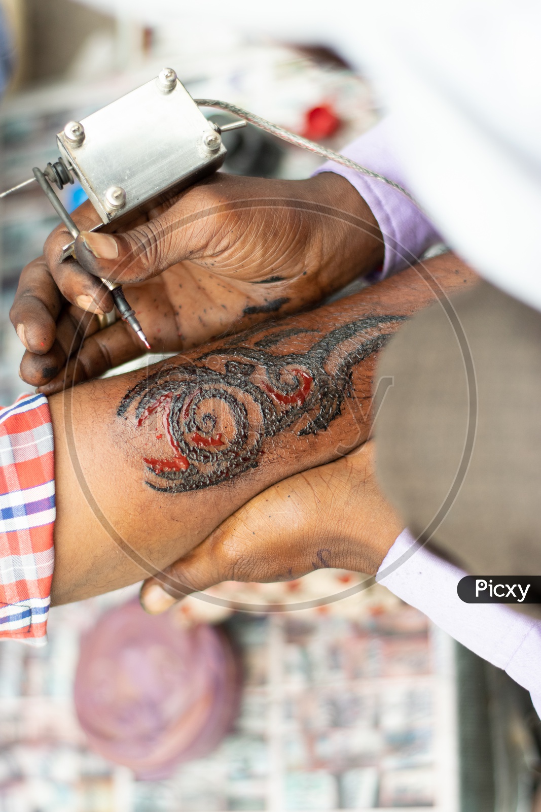 Roadside Artist doing Tattoos on a Indian Man