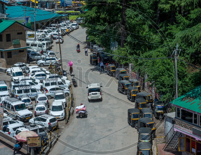 Cabs and Autos Parked on Road in Manali