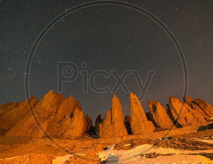 Mountain rocks under stars in night at Spiti Valley in Winter