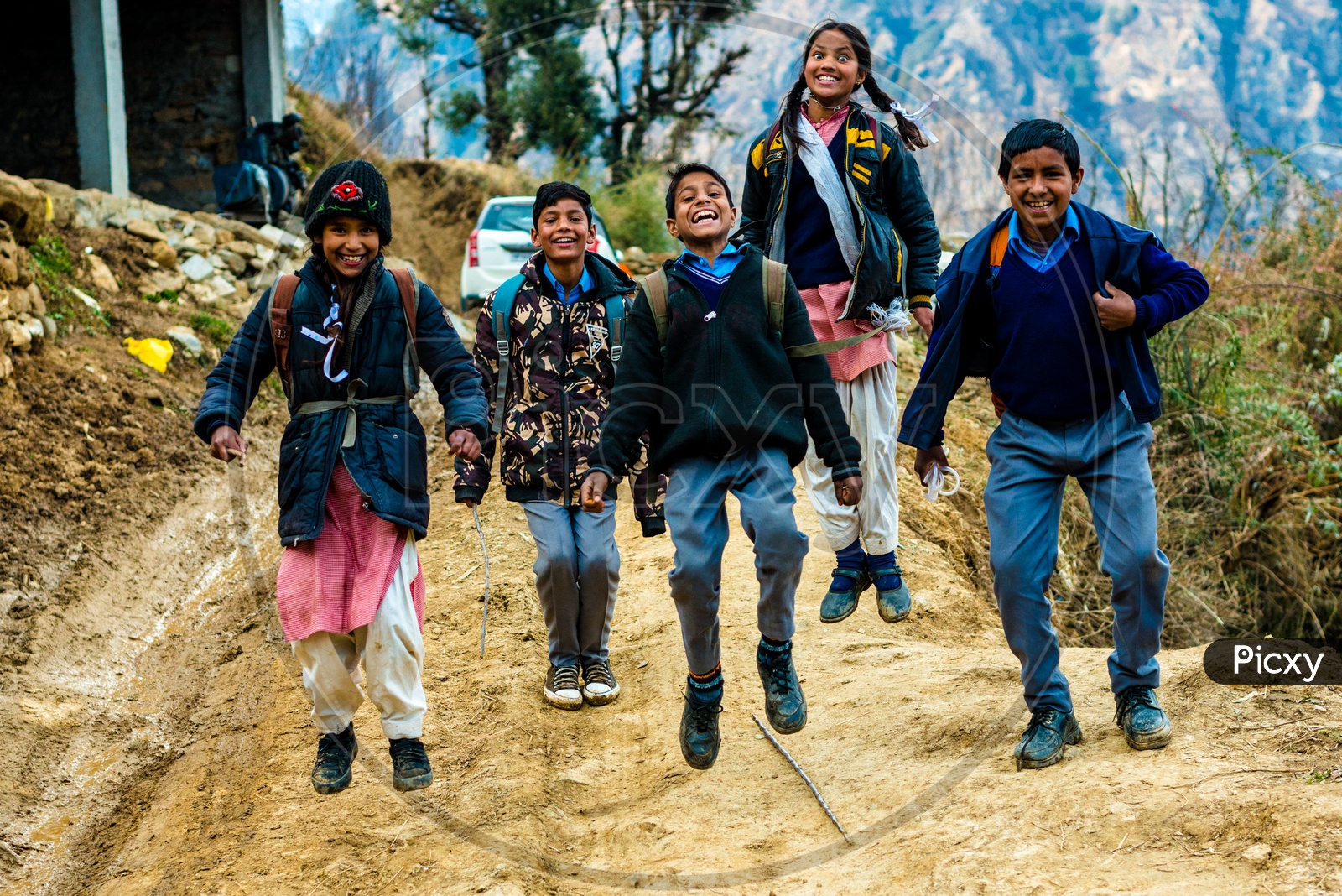 Portrait of Indian School Kids Jumping and Smiling on the Street