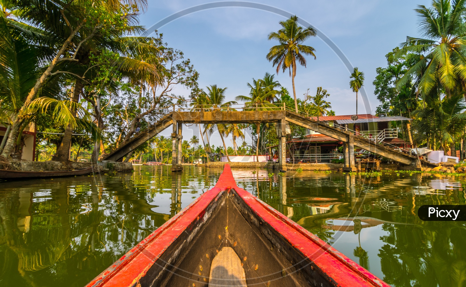 A boat crossing the bridge on the backwaters