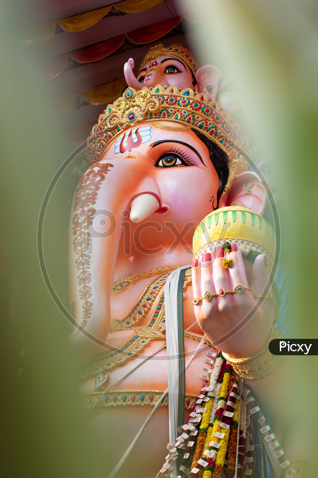 Ganesh Ganapati- Elephant God In Hindusim Mythology Closeup Hold The  Weapons Maze And Axe Pose Right Side Split-tone Stock Photo, Picture and  Royalty Free Image. Image 46072197.
