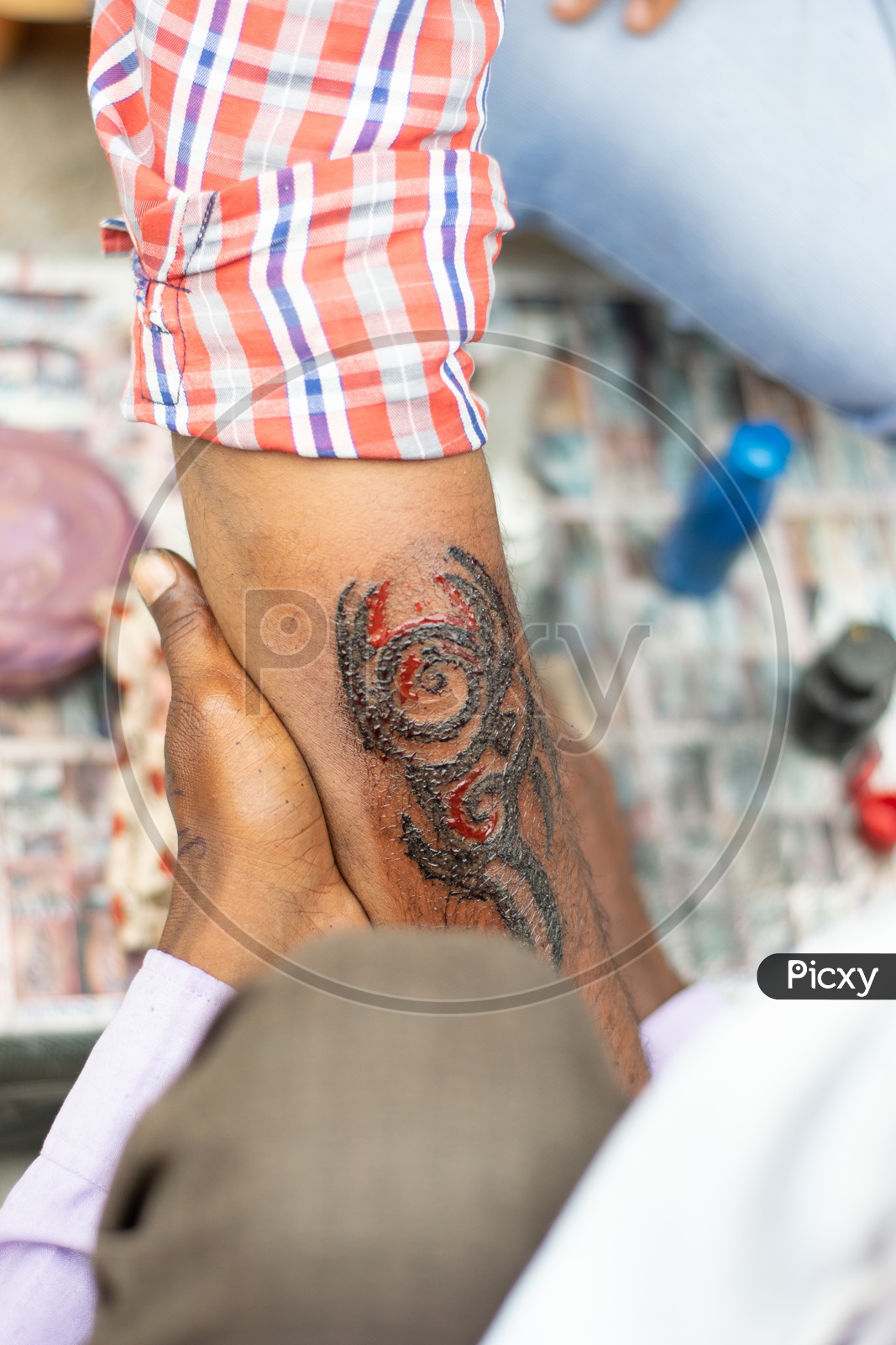 Roadside Artist doing Tattoos on a Man