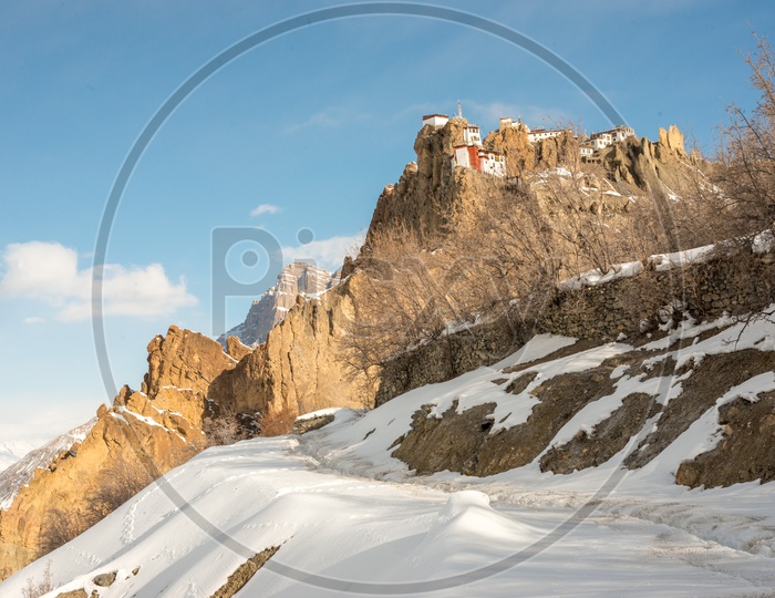Dhankar Monastery on Mountain in Snow with Clouds in Sky