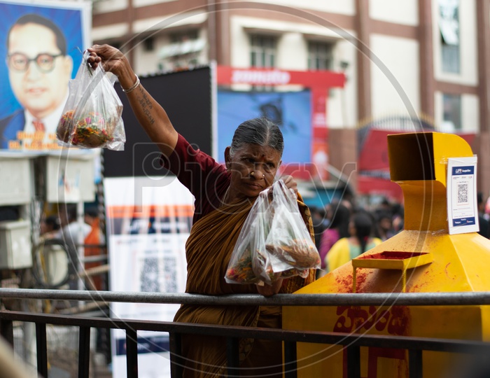 Indian Old Woman Selling Pooja Items at Hindu Temple