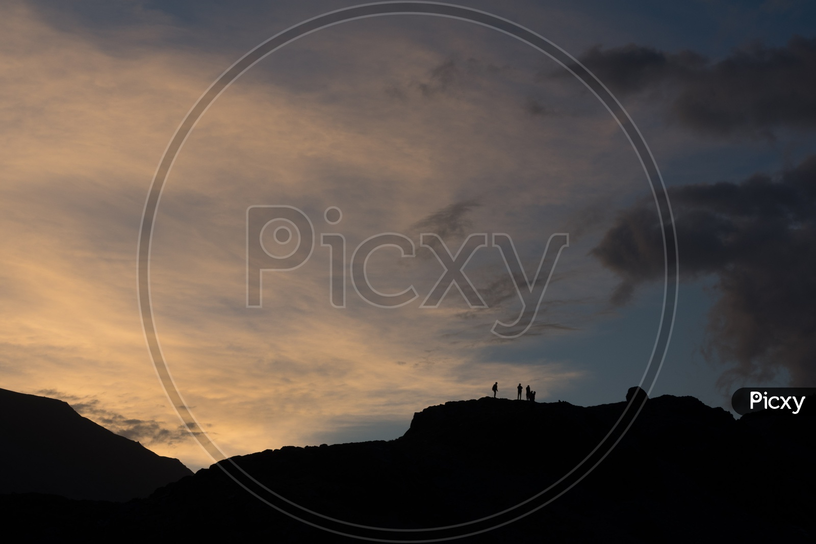 Silhouette of travellers on top of the mountain