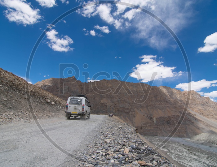 A car moving along the dirt mountain road at  Lahaul And Spiti