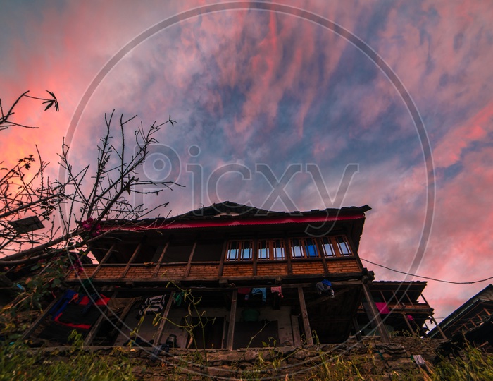 Sunset over traditional wooden house
