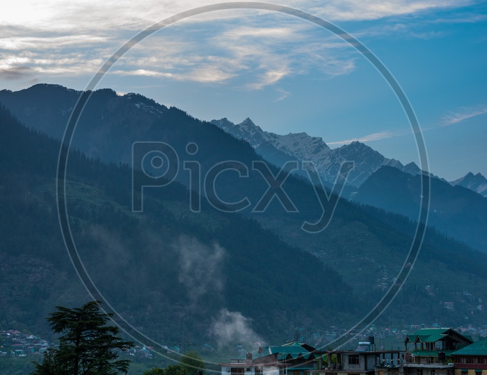 Himalaya Mountain ranges during sunset alongside Himalayan village in manali