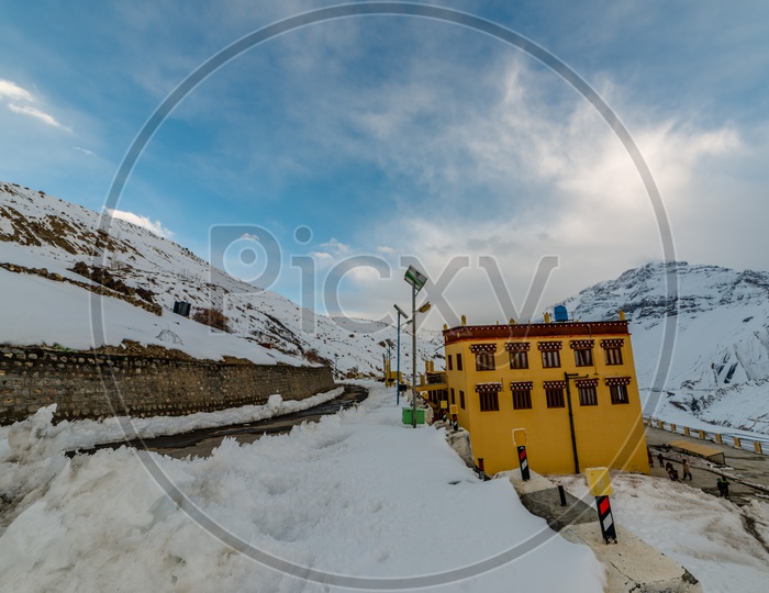 Dhankar Monastery Covered in Snow with Snowy Himalayan Mountains in Background
