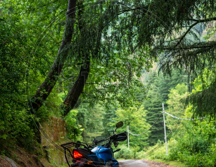 A Bike parked in the middle or dirt road