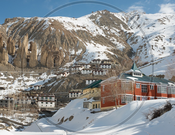 A Village in Spiti on Mountain Covered in Snow Surrounded by Snowy Himalayan Mountain Peaks in Winter