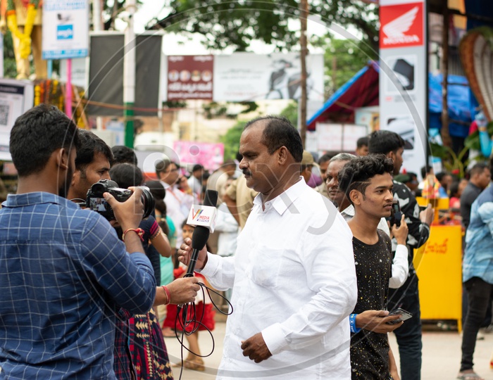 Man giving interview to Journalists or Media at Khairatabad Ganesha Temple