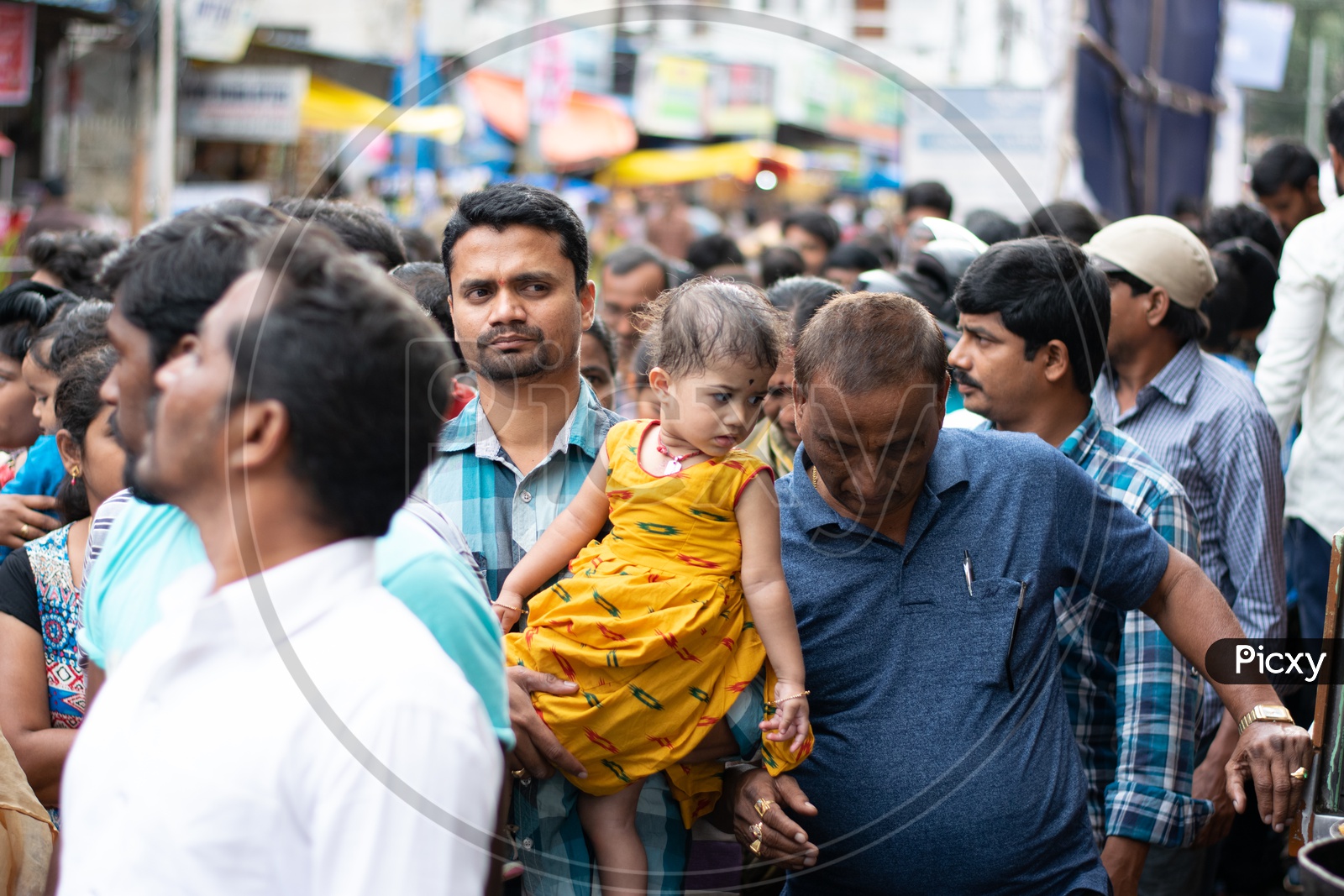 Indian Father with his Child in a Queue waiting at Khairatabad Ganesh Temple
