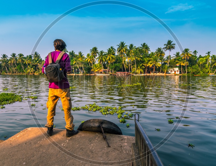 A Tourist enjoying the view of backwaters