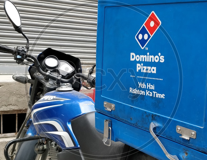 Dominos pizza delivery vehicle mounted with the box