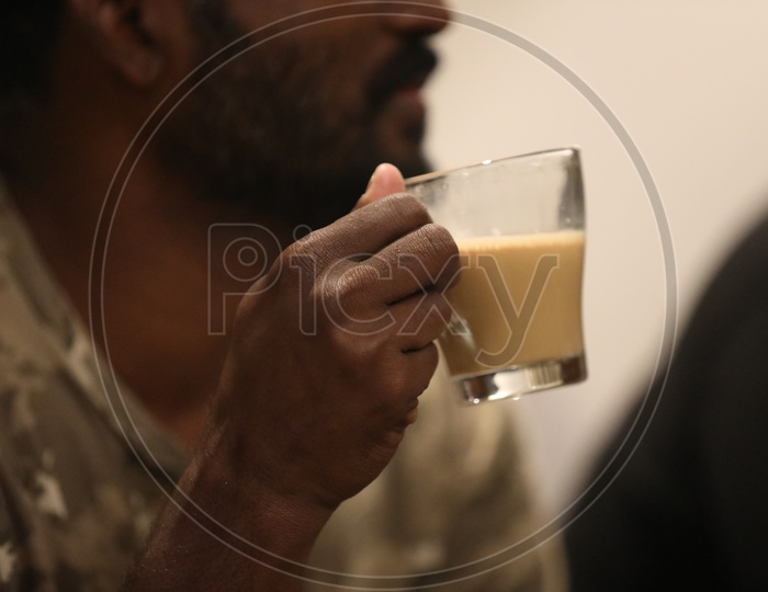 Indian Man holding a tea cup