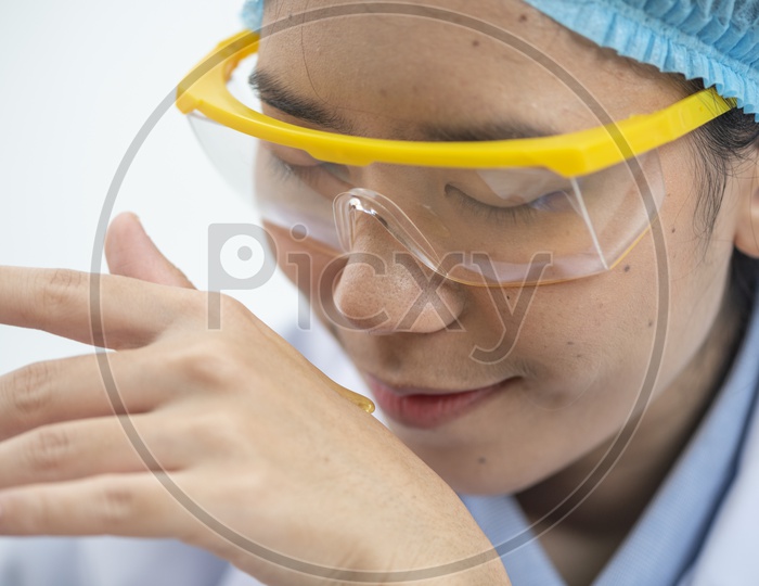 A Female Dermatology Researcher testing the oraginc serum in the laboratory