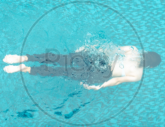 Asian girl swimming in a swimming pool