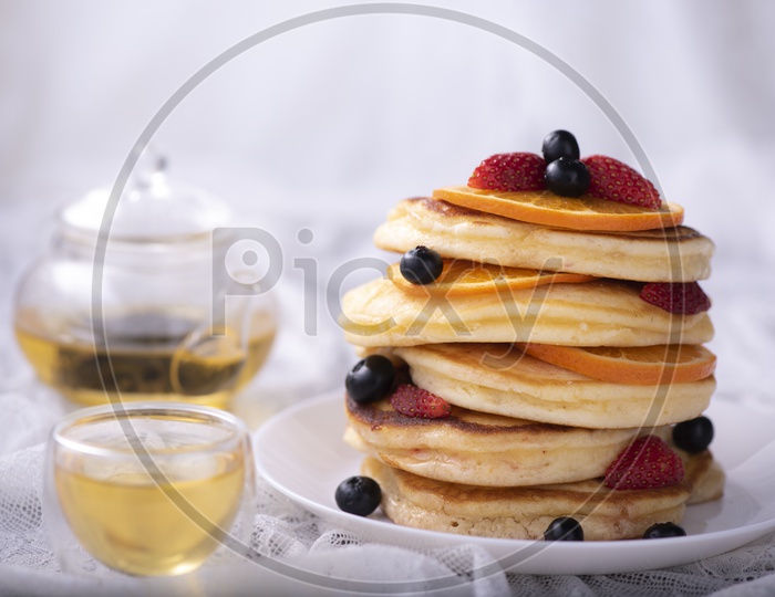 pancake stack with berries fruit and Maple syrup