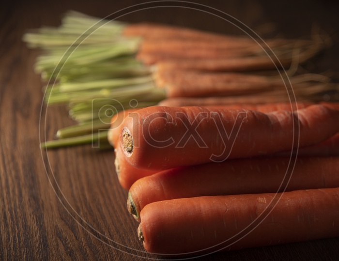Fresh Red Carrots On Wooden Table Background