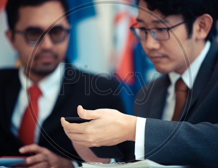 Businessmen using a smartphone during meeting