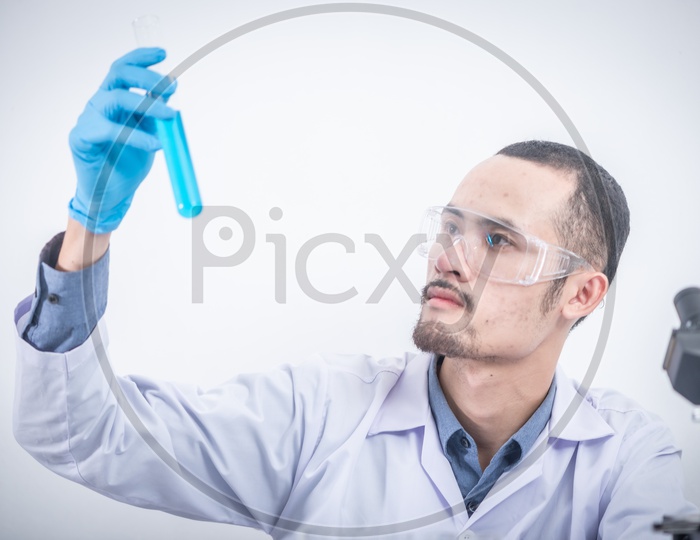 Researcher Or Scientist Testing Various Chemicals As a Part of  Research in a  Laboratory