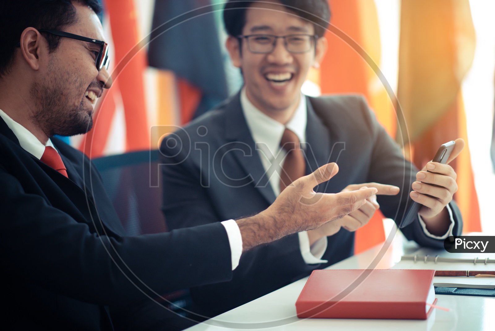 International Businessmen smiling using a smartphone