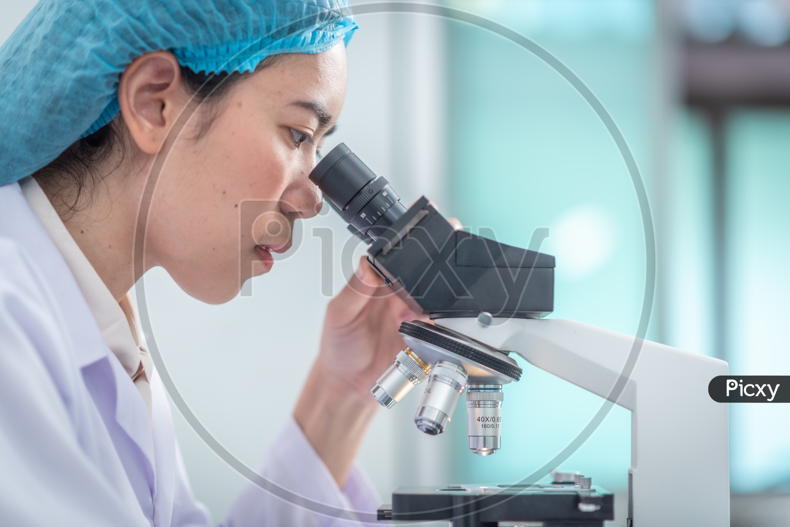 Asian Student Using Microscope in Pharma Laboratory