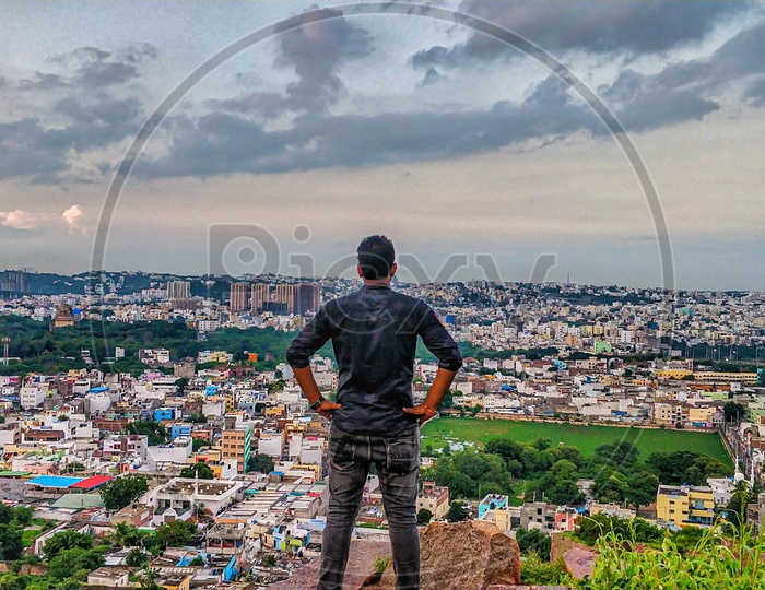 A Man Enjoying The City Scape View  From a Hill top