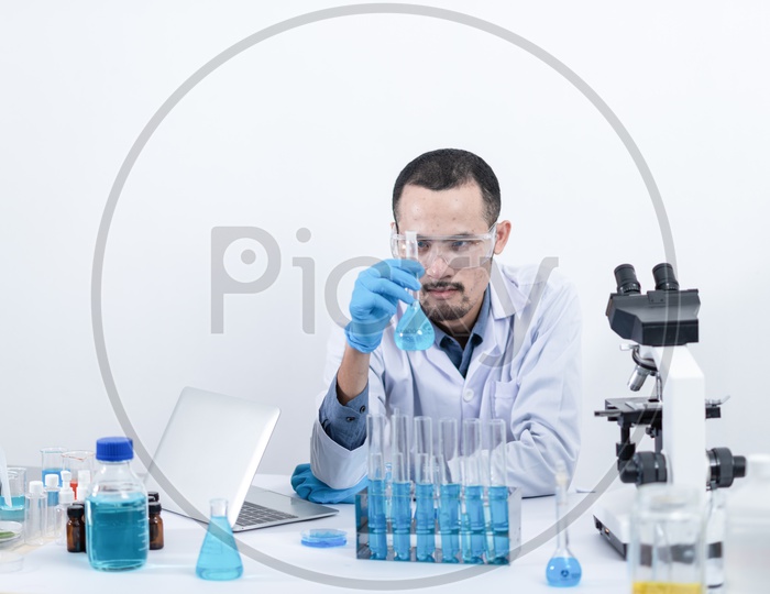 Scientist Or Researcher Analyzing a Sample In Laboratory  With Equipment