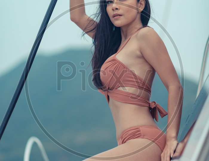 A fashion outdoor photoshoot of a model in luxurious nude bikini