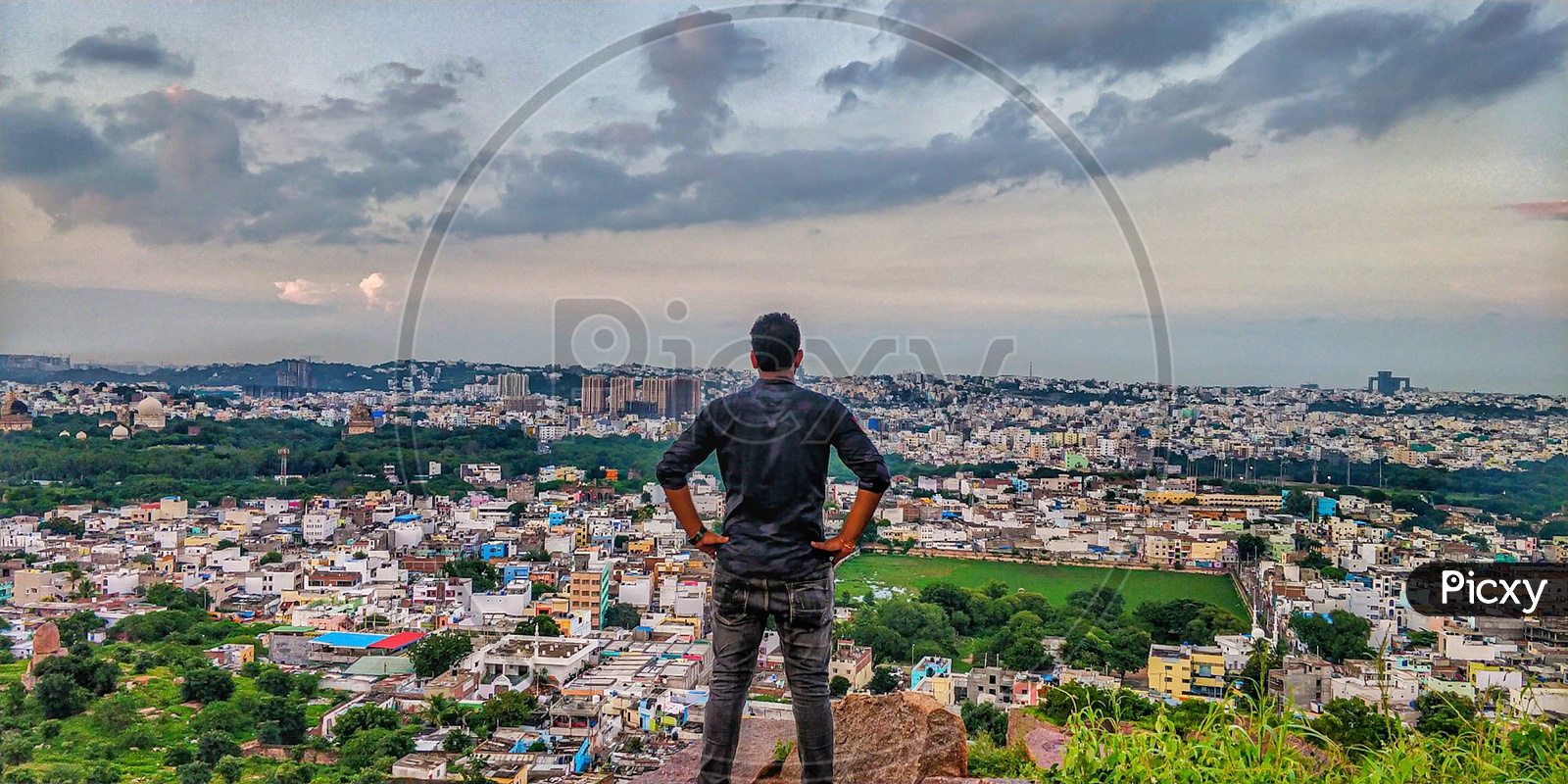 A Man Enjoying The City Scape View  From a Hill top
