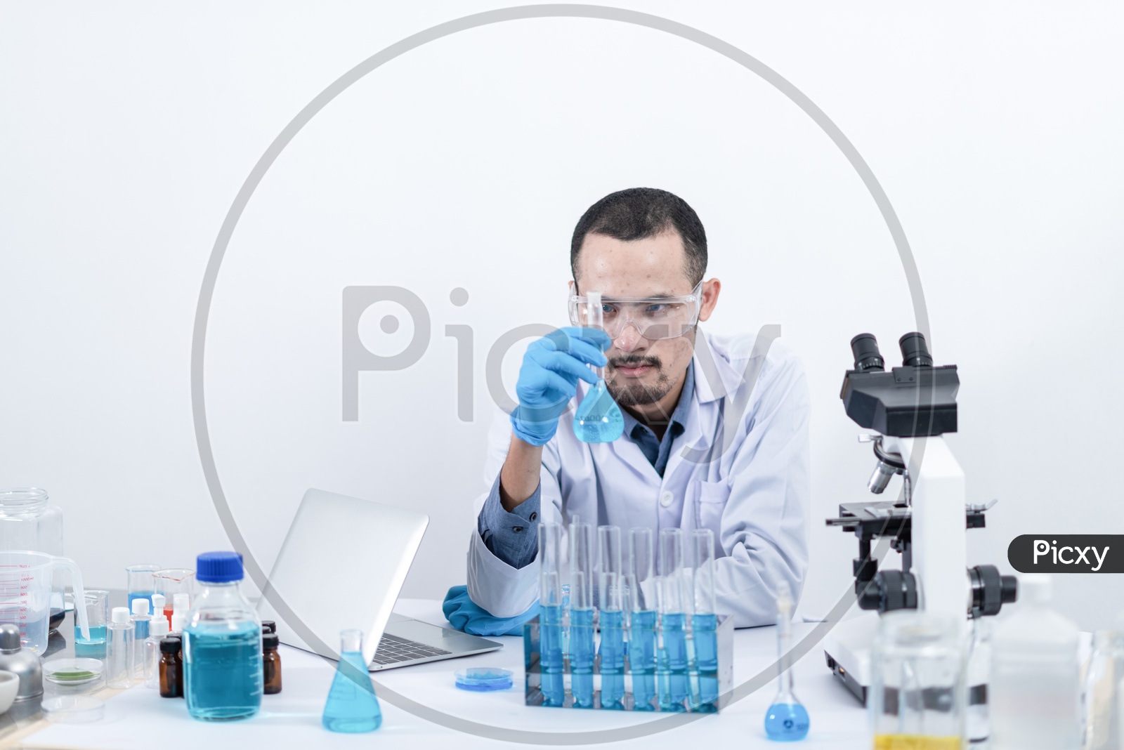 Scientist Or Researcher Analyzing a Sample In Laboratory  With Equipment