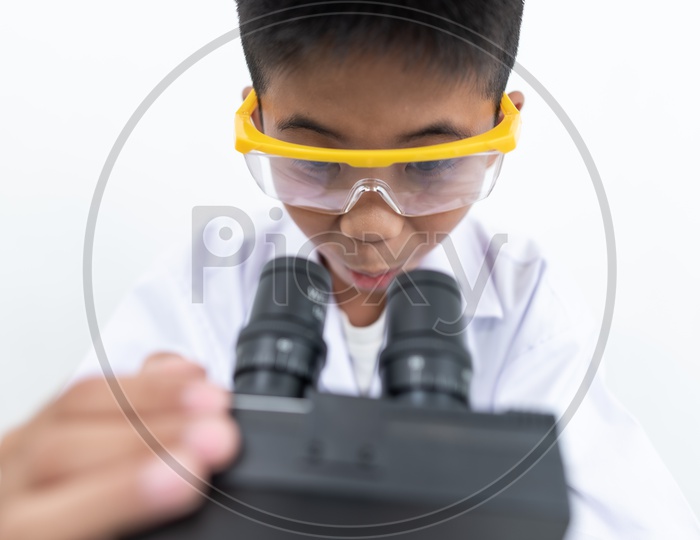 A Young asian boy experiencing microscope at laboratory.
