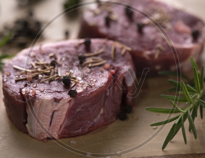 Raw Beef Steaks On Wooden Cutting Board Closeup