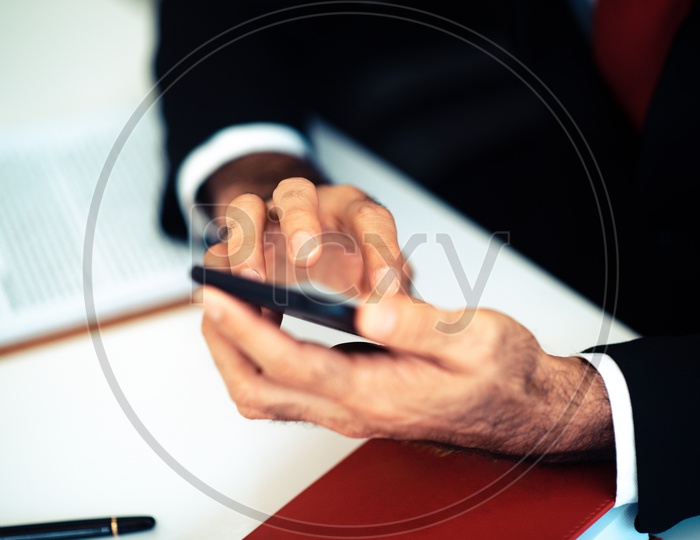 A smartphone in the hands of a Businessman