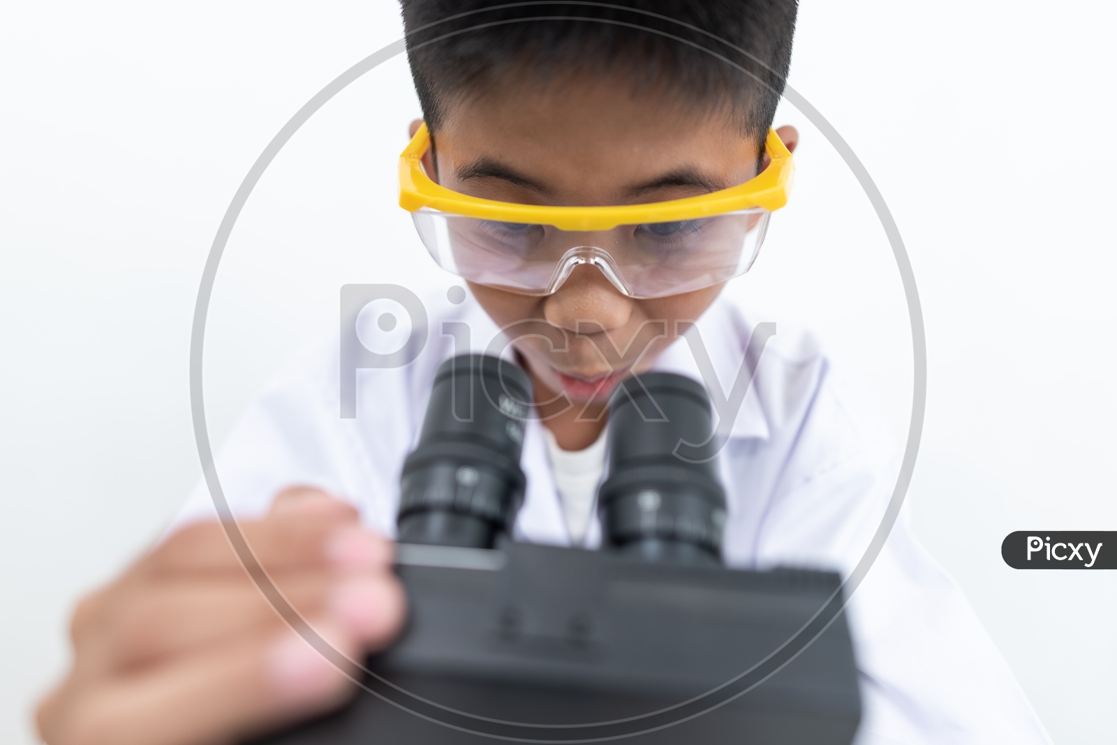 A Young asian boy experiencing microscope at laboratory.