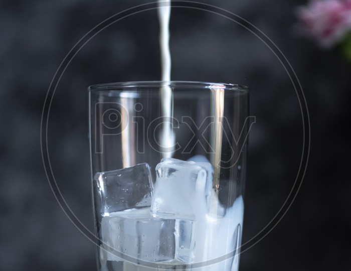Fresh cold milk with ice in a glass