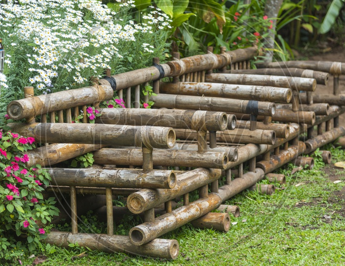 Chairs  Made Of Dried Bamboo Logs  in a Flower Garden