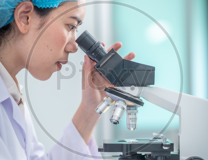 Pharma Student Using Microscope In a Lab For Analysis