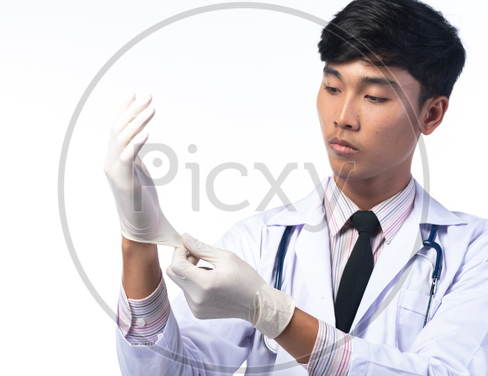 Young Doctor Wearing Surgical Gloves Over White Background