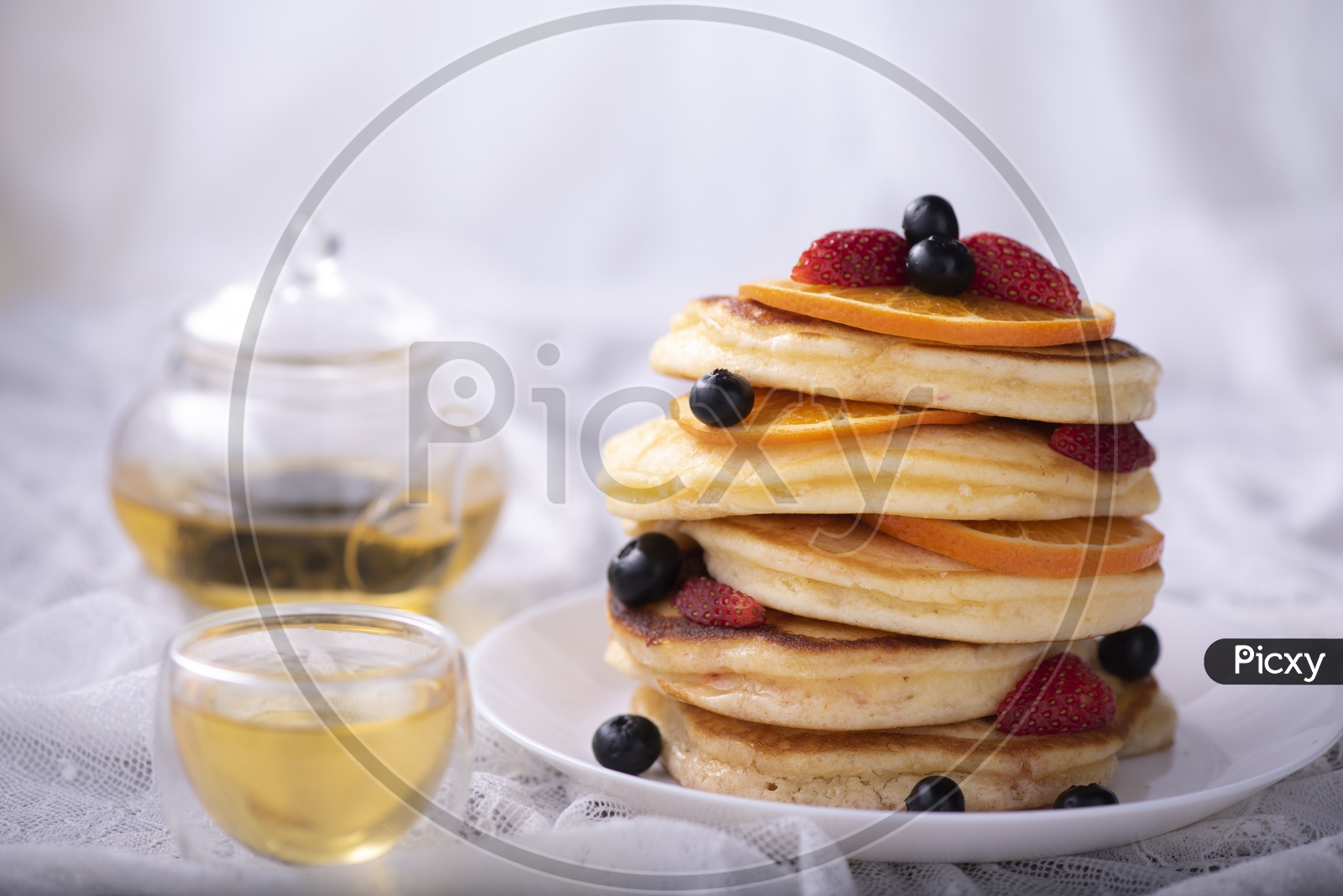 pancake stack with berries fruit and Maple syrup