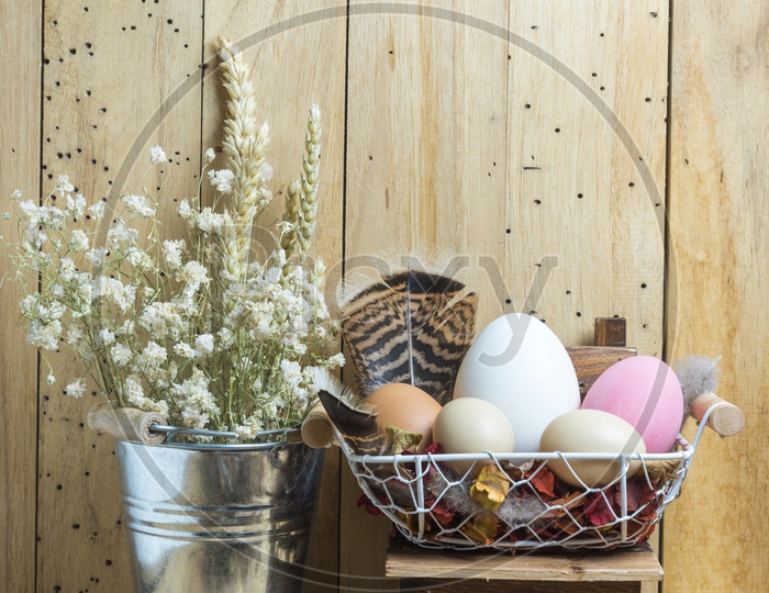 Easter Festival Artistic Backgrounds With Vintage Flowers And Eggs Bunch In A Basket Over Wooden Background