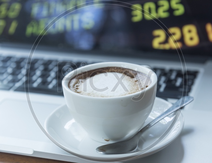 Coffee Cup Closeup with the stock market  Readings Bokeh Background