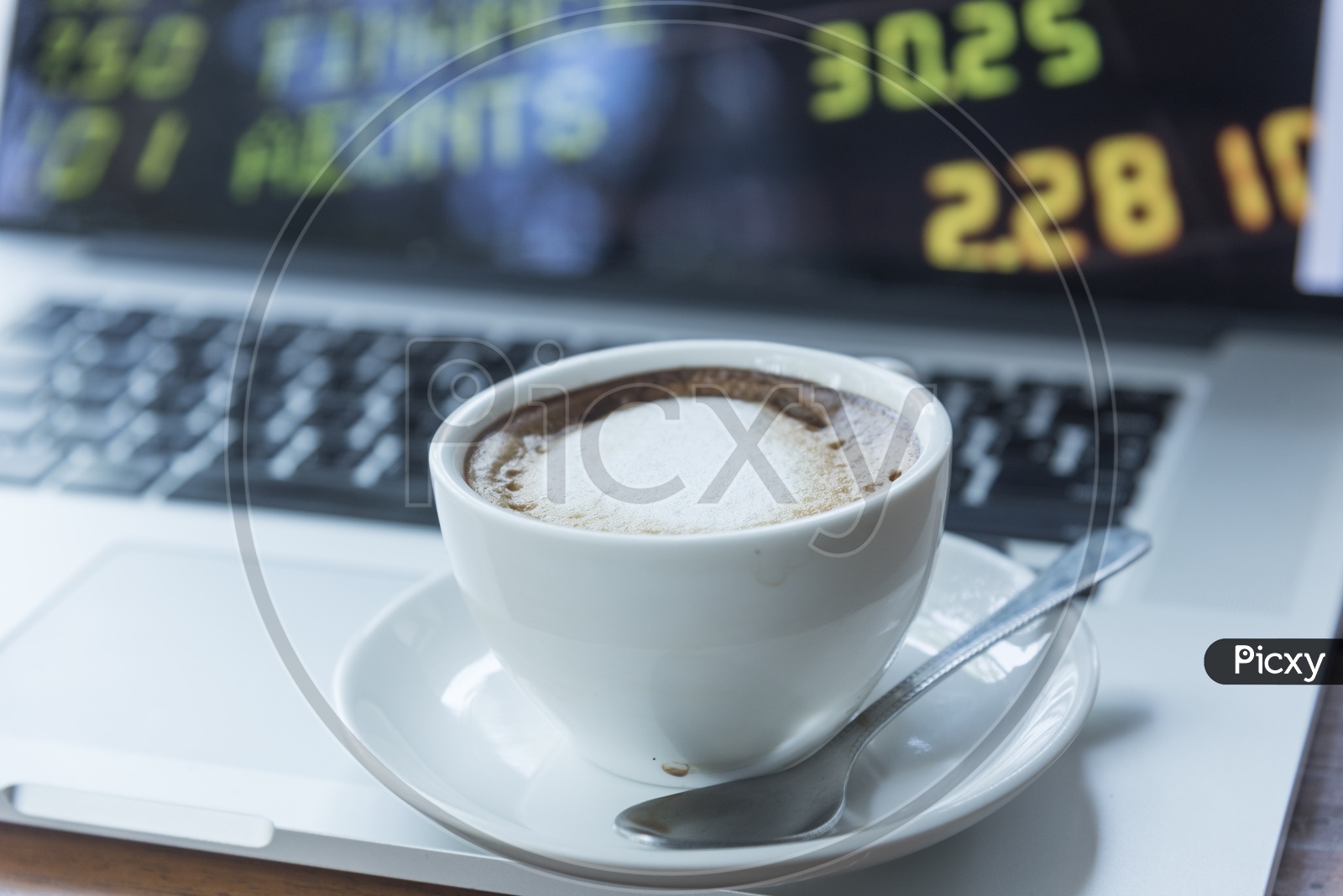 Coffee Cup Closeup with the stock market  Readings Bokeh Background