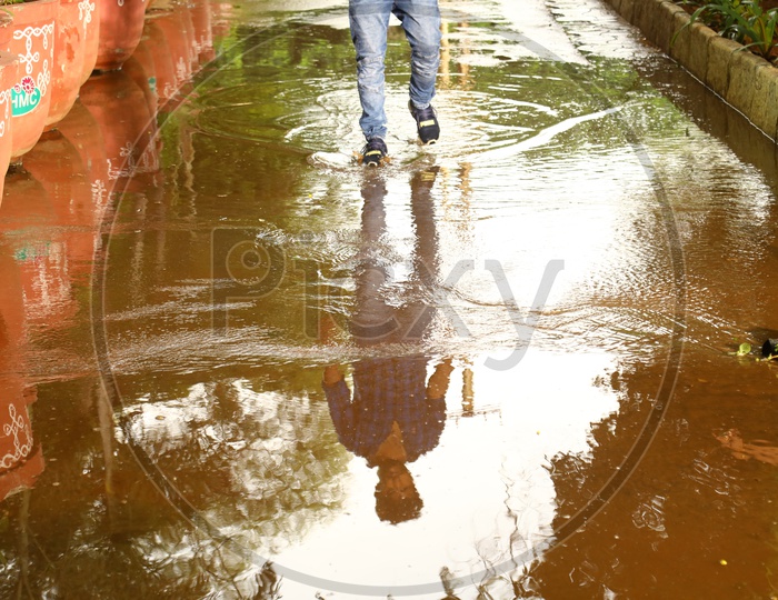 Reflection of a man walking on the water