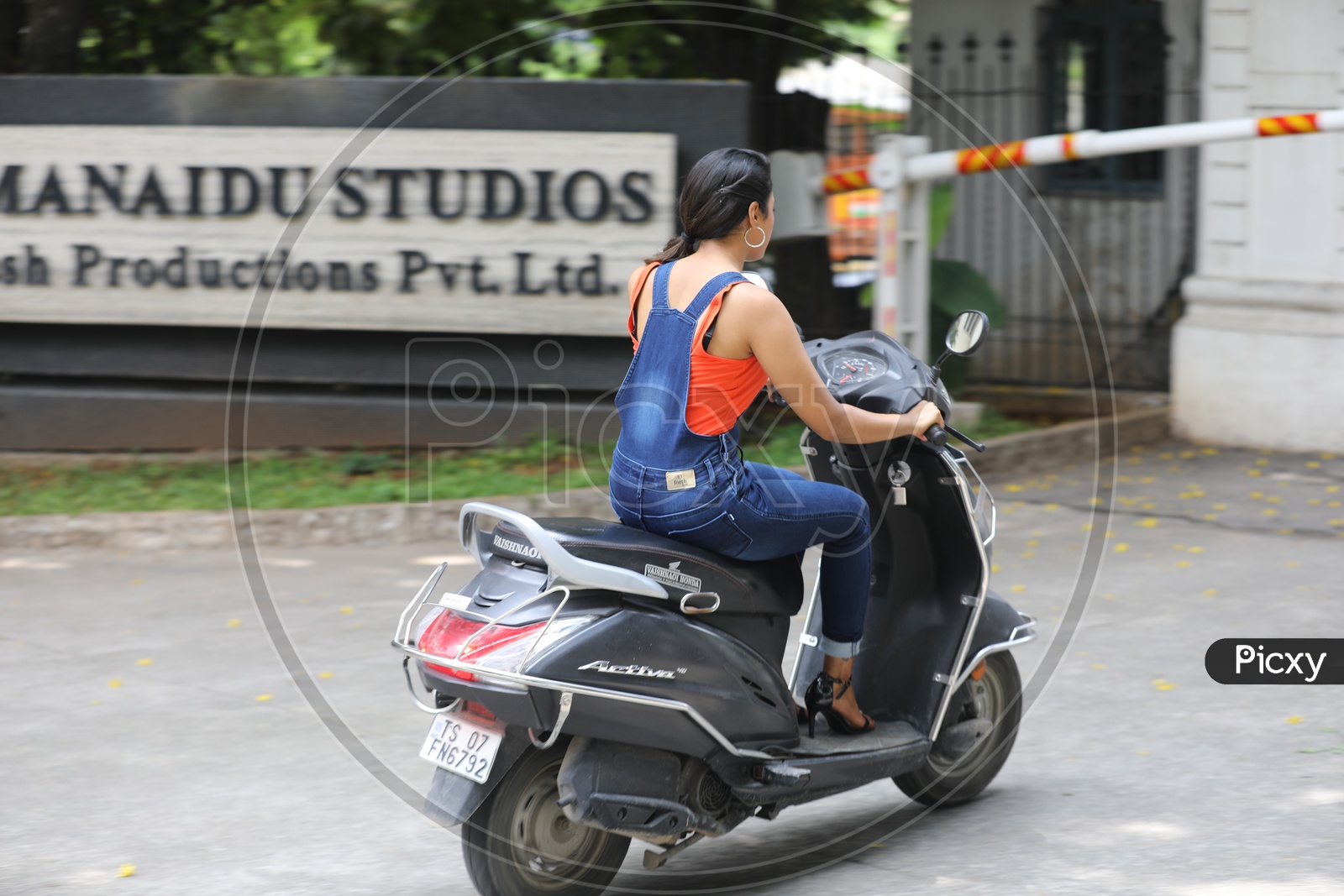 Image of Indian girl riding Activa Scooter HR071415 Picxy