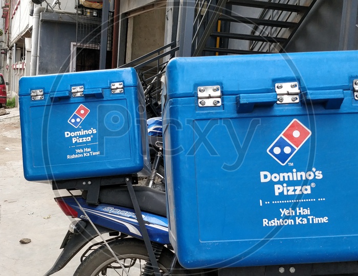 Domino's pizza delivery service boxes mounted on a bike/ motorcycle